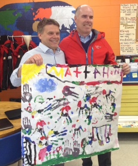 Ed Milano and Bob Klein show off the finger painting they made with Mattahunt students.